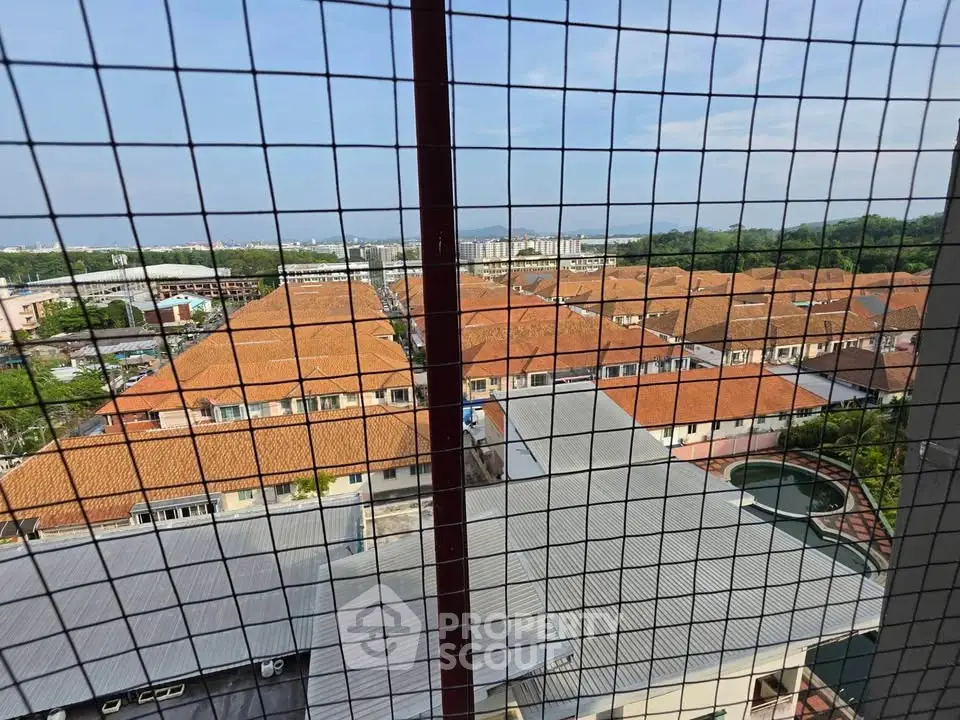 Stunning aerial view of residential area with red-tiled roofs and lush greenery, showcasing serene suburban living.