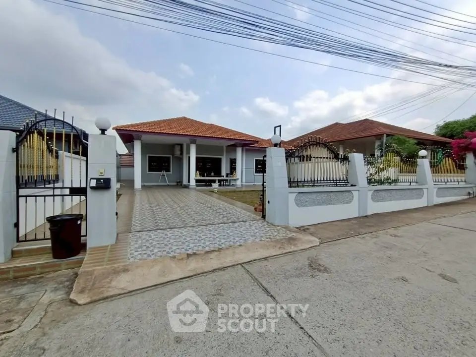 Charming suburban home with spacious driveway and gated entrance