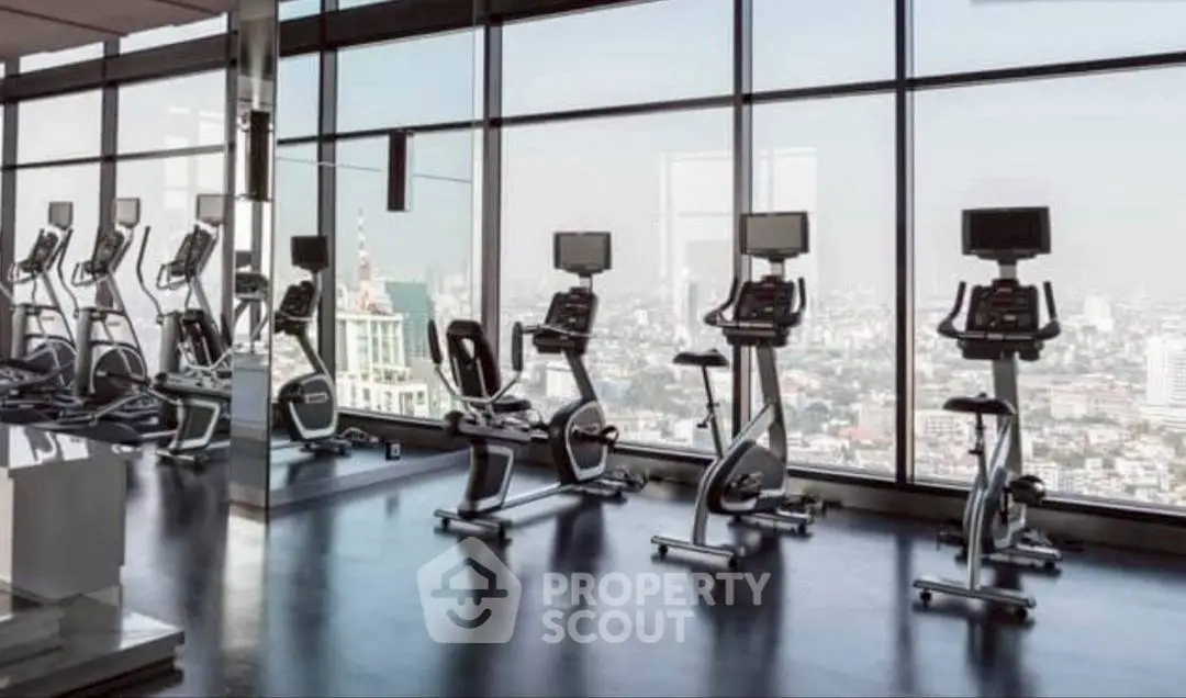 Luxurious high-rise gym with panoramic city views and modern exercise equipment.