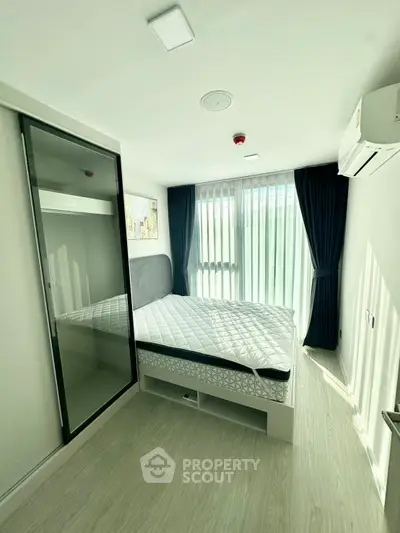 Bright and modern bedroom with large window and sleek design