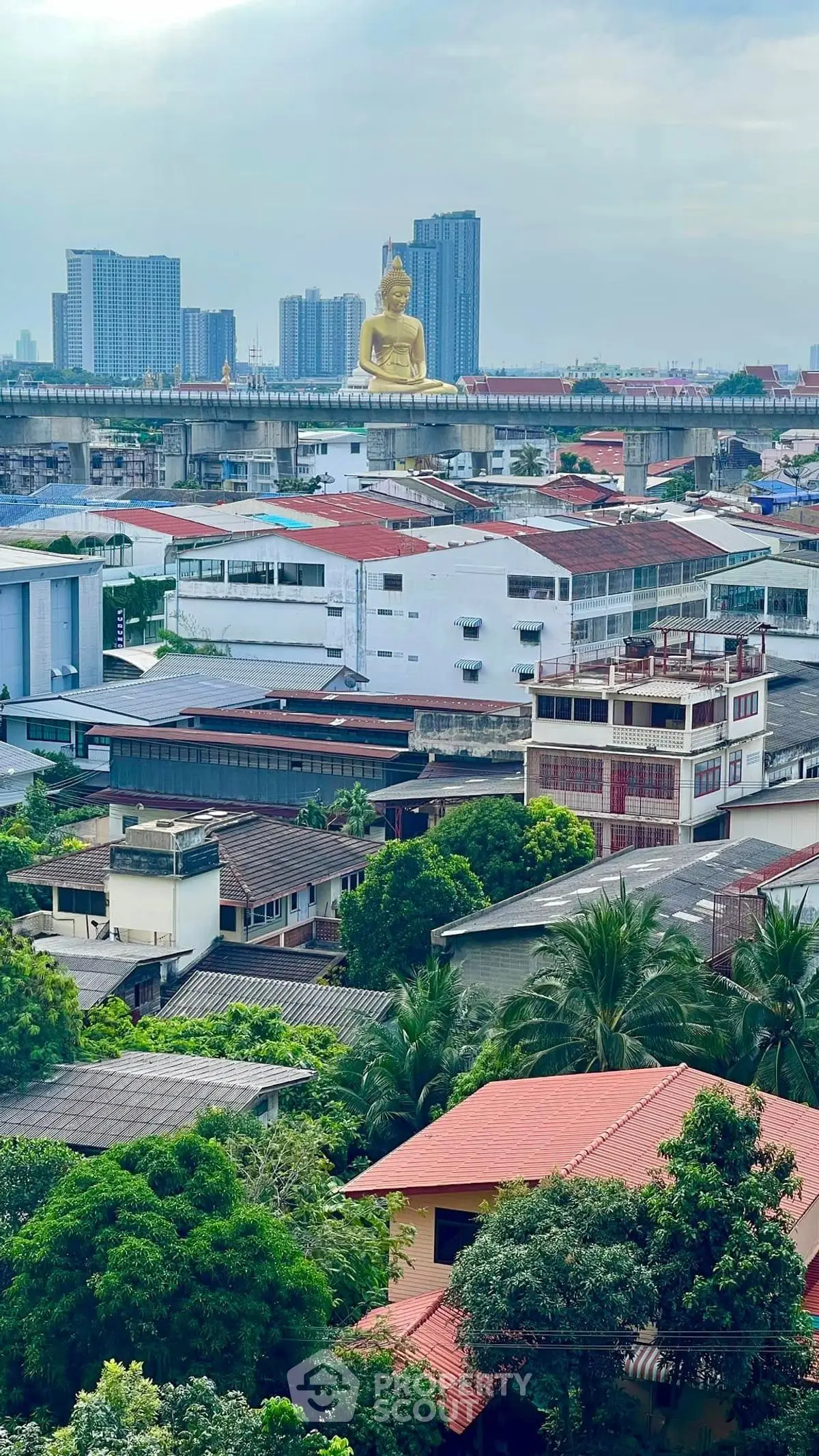 Stunning cityscape view featuring a golden Buddha statue and modern skyline, ideal for urban living enthusiasts.