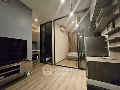 Modern studio apartment with sleek design and open layout, featuring a cozy living area and stylish kitchen.