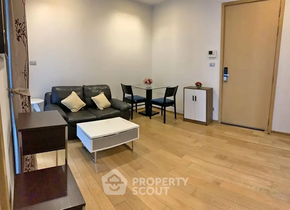 Modern living room with wooden flooring and stylish furniture in a cozy apartment.