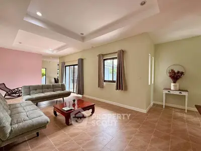 Spacious living room with modern decor and ample natural light, perfect for family gatherings.