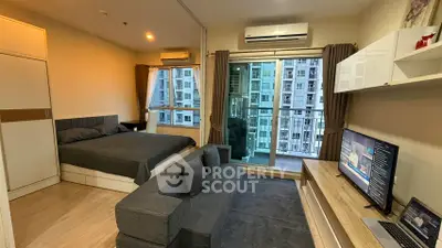 Modern studio apartment with balcony and city view, featuring cozy living area and stylish decor.