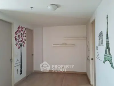 Spacious room with minimalist decor and wall art, ideal for creative living space.