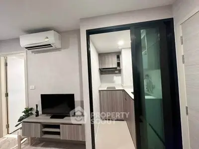 Modern compact living room with sleek kitchen and air conditioning