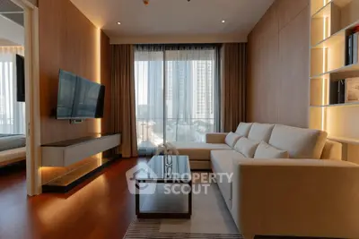 Modern living room with elegant decor and city view, featuring a large sofa and wall-mounted TV.