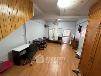 Spacious study room with wooden flooring and modern furniture