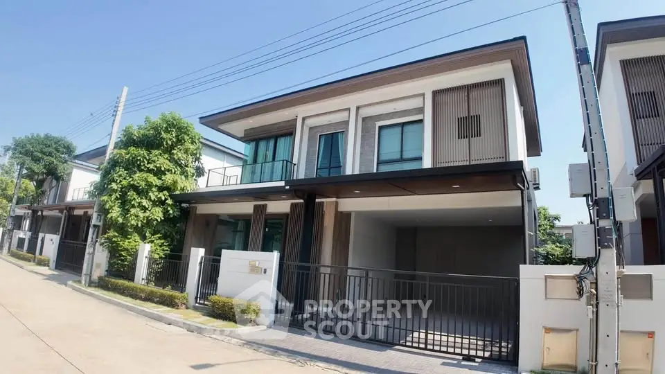 Modern two-story house with sleek design and spacious driveway in a serene neighborhood.