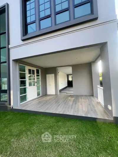 Modern home exterior with spacious balcony and large windows