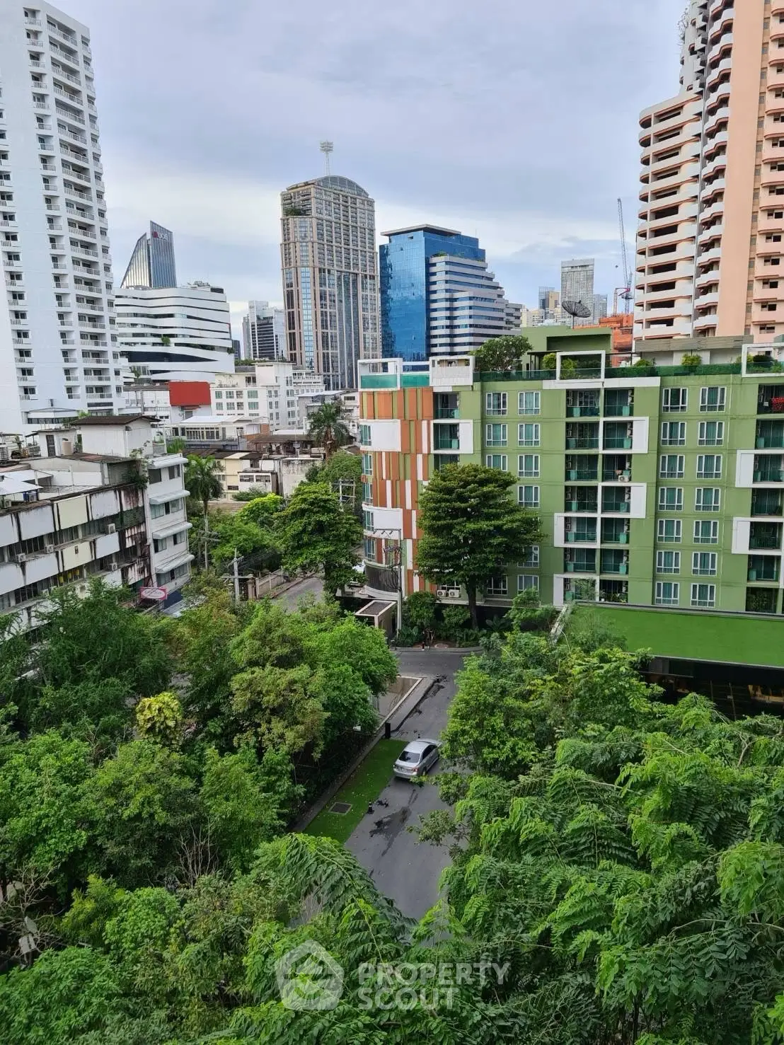 Stunning cityscape view with modern high-rise buildings and lush greenery