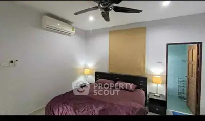 Cozy bedroom with modern ceiling fan and air conditioning, perfect for restful nights.