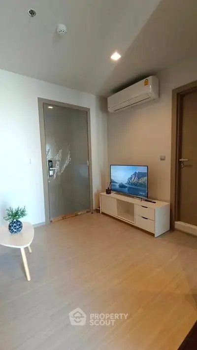 Modern living room with air conditioning and sleek TV setup