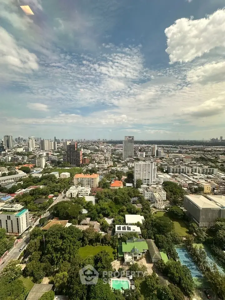 Stunning cityscape view from high-rise building showcasing urban skyline and lush greenery.