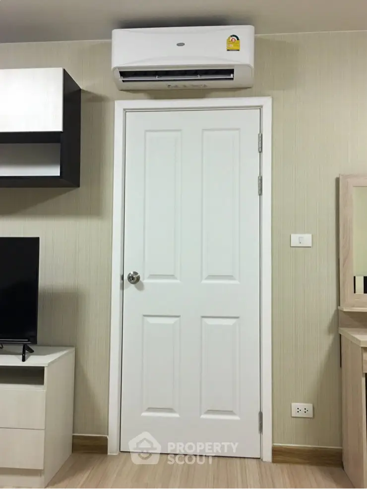 Modern interior with air conditioning and sleek door design in a cozy living space.