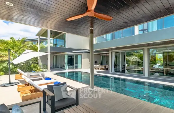 Luxurious modern villa with private pool and spacious outdoor lounge area.