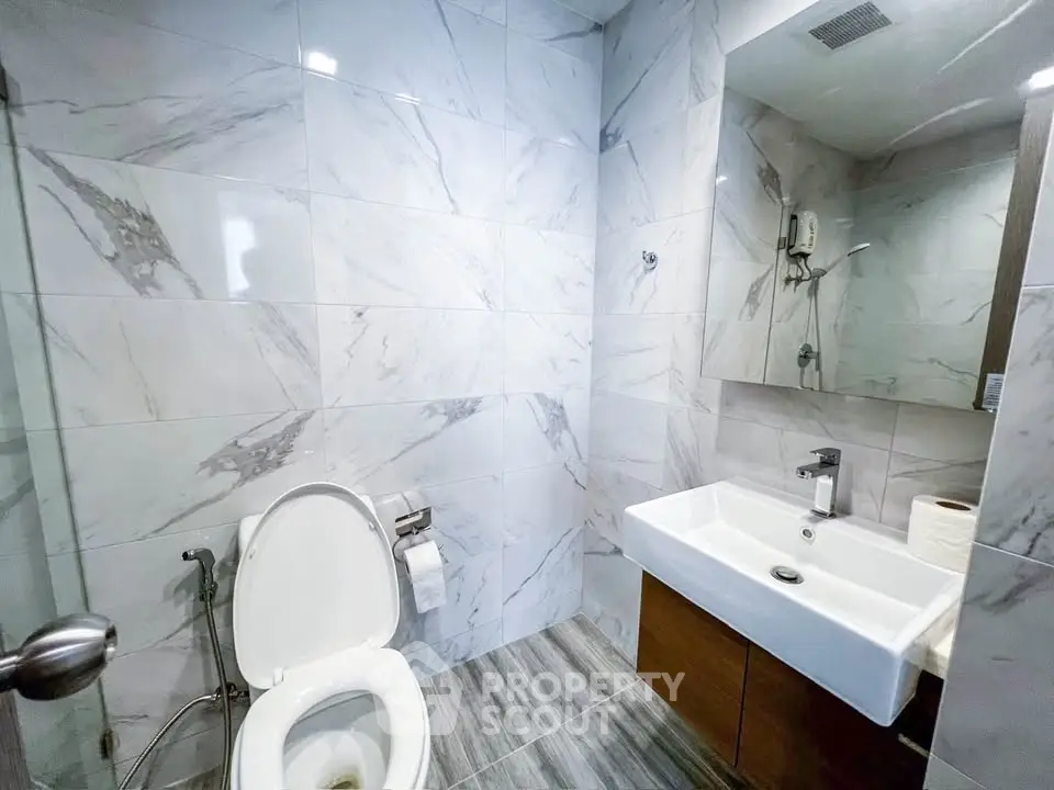 Modern bathroom with marble tiles and sleek fixtures