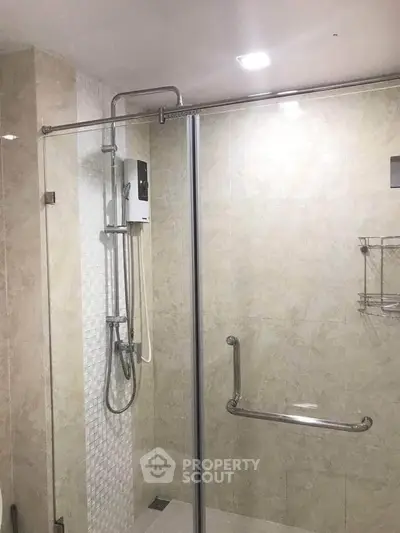 Modern bathroom with glass shower enclosure and sleek fixtures