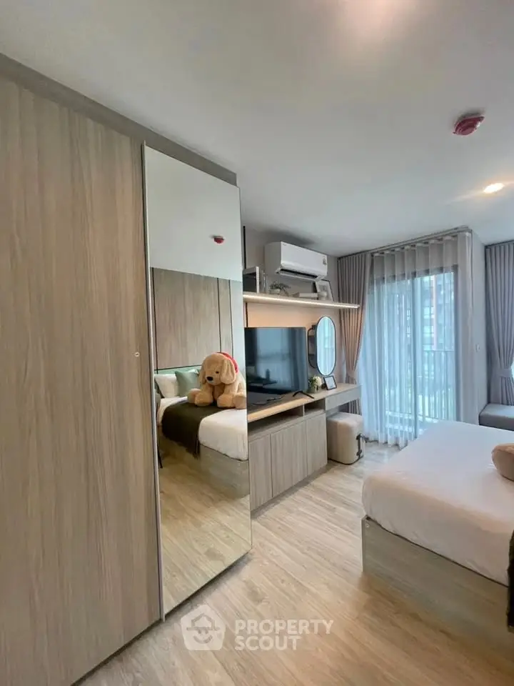 Modern bedroom with mirrored wardrobe and cozy decor in a stylish apartment.