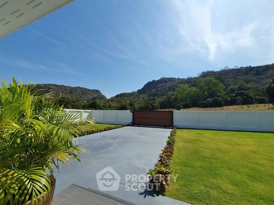 Stunning garden view with lush greenery and mountain backdrop, perfect for serene living.