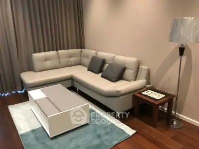 Modern living room with stylish sectional sofa and sleek coffee table on hardwood floor.