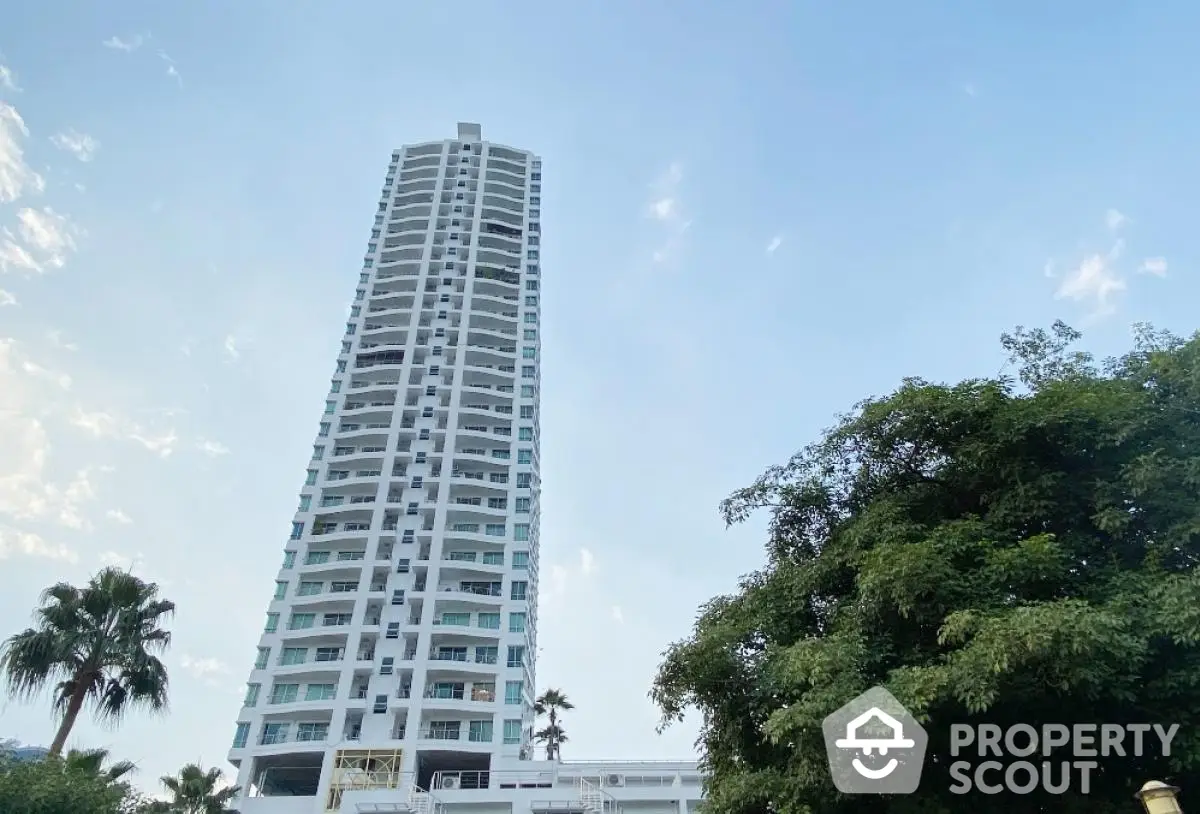 Stunning high-rise building with modern architecture and lush greenery, perfect for urban living.