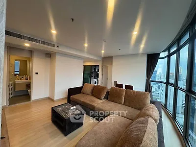 Spacious modern living room with city view and cozy seating area
