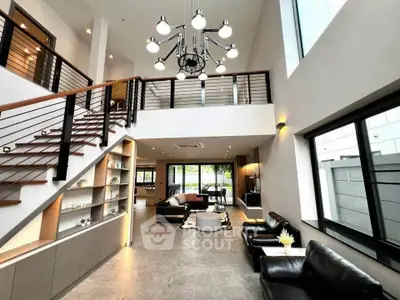 Stunning modern living room with high ceilings and elegant staircase
