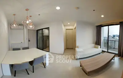Modern living room with dining area and city view balcony in a stylish apartment.