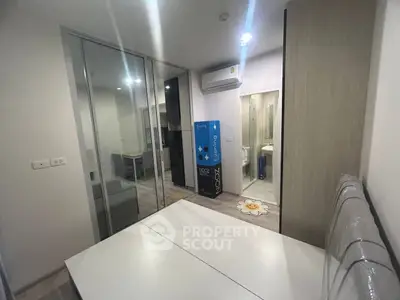 Modern bedroom with mirrored closet and air conditioning in stylish apartment