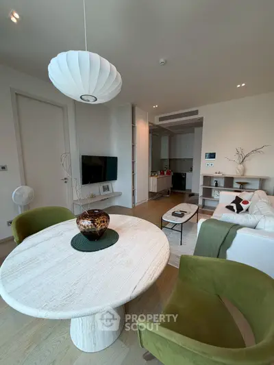 Modern living room with stylish furniture and open layout, featuring a cozy seating area and elegant decor.