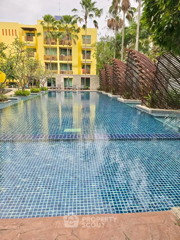 Stunning poolside view with lush greenery and modern architecture, perfect for relaxation and leisure.