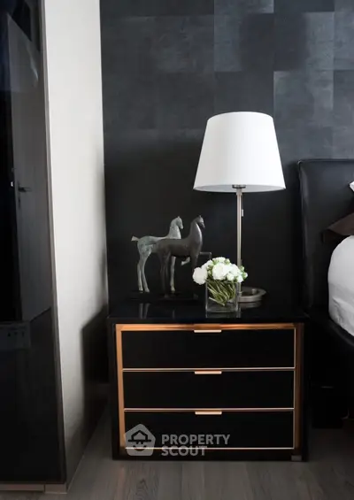 Stylish bedroom nightstand with modern lamp and decor