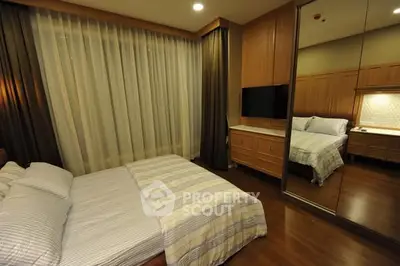 Luxurious bedroom with mirrored wardrobe and elegant lighting