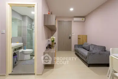 Modern apartment interior with cozy living room and adjacent bathroom