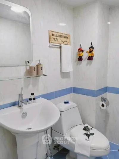 Charming bathroom with modern fixtures and playful decor accents.