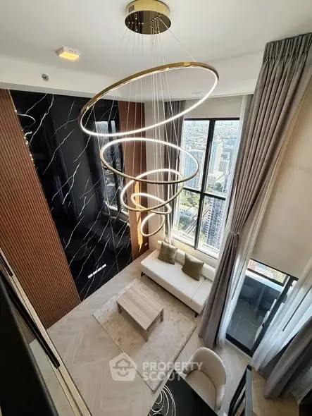 Luxurious modern living room with stunning city view and elegant spiral chandelier.