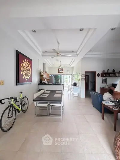 Spacious open-plan living room with modern decor and natural light