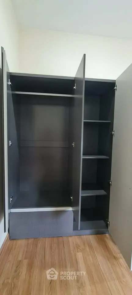Spacious modern wardrobe with sleek design and ample shelving in a stylish interior.