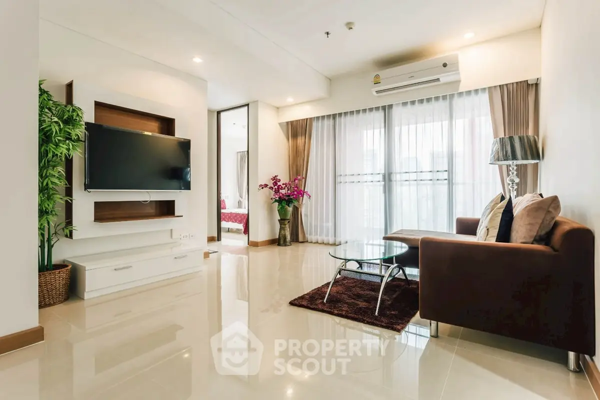 Spacious modern living room with elegant decor and large windows for natural light.