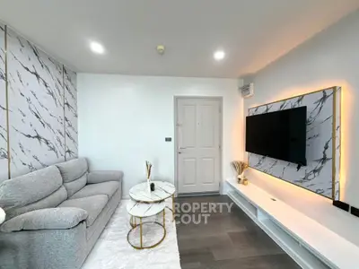 Modern living room with stylish marble accents and sleek TV setup