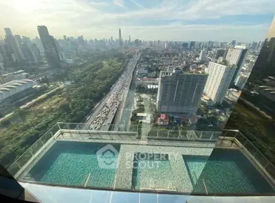 Stunning cityscape view from high-rise building with luxurious rooftop pool.