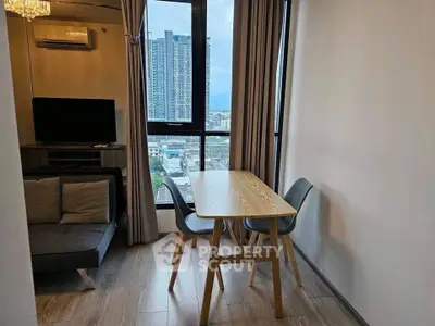 Modern living room with city view, featuring sleek furniture and large windows for natural light.