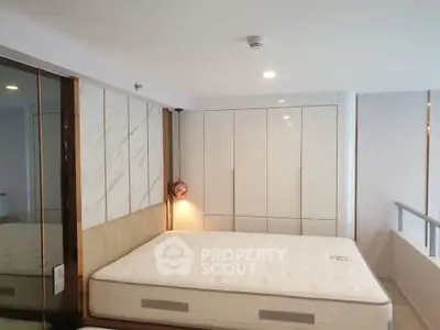 Modern bedroom with sleek wardrobe and comfortable mattress in stylish apartment.