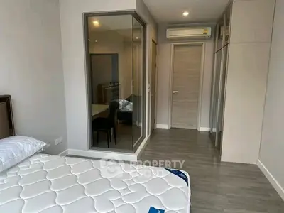 Modern bedroom with sleek design, featuring a comfortable bed and ample storage space.