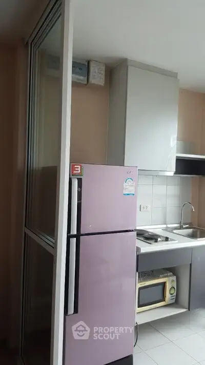 Compact kitchen with modern appliances and sleek cabinetry