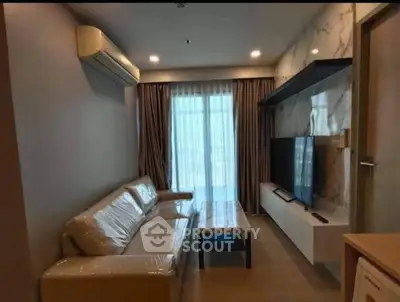 Modern living room with sleek furniture and large window for natural light.