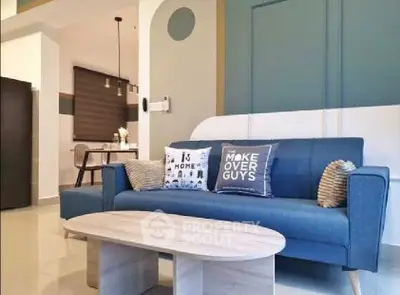 Stylish living room with modern blue sofa and chic decor