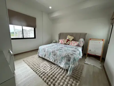 Cozy bedroom with plush bedding and natural light in modern home